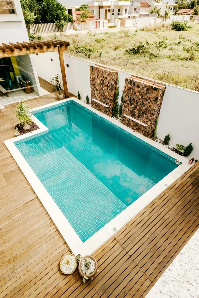 blue swimming pool near green trees during daytime